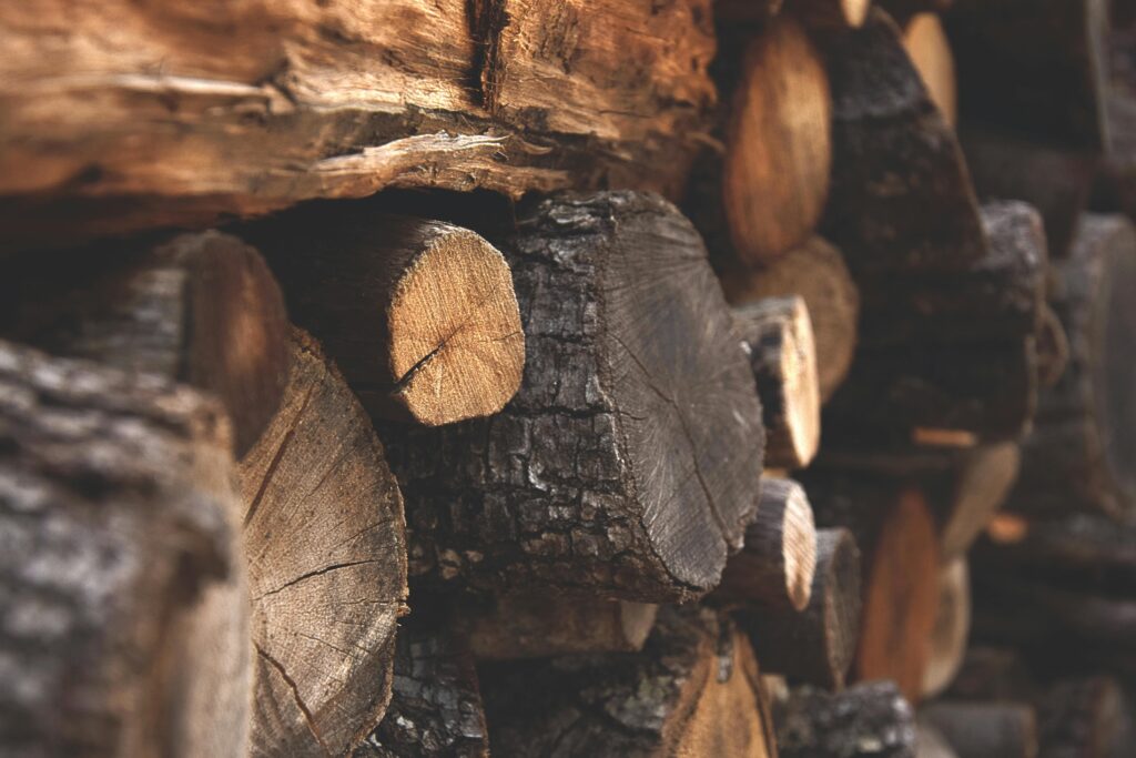 Detailed view of stacked chopped wood showing texture and warmth.
