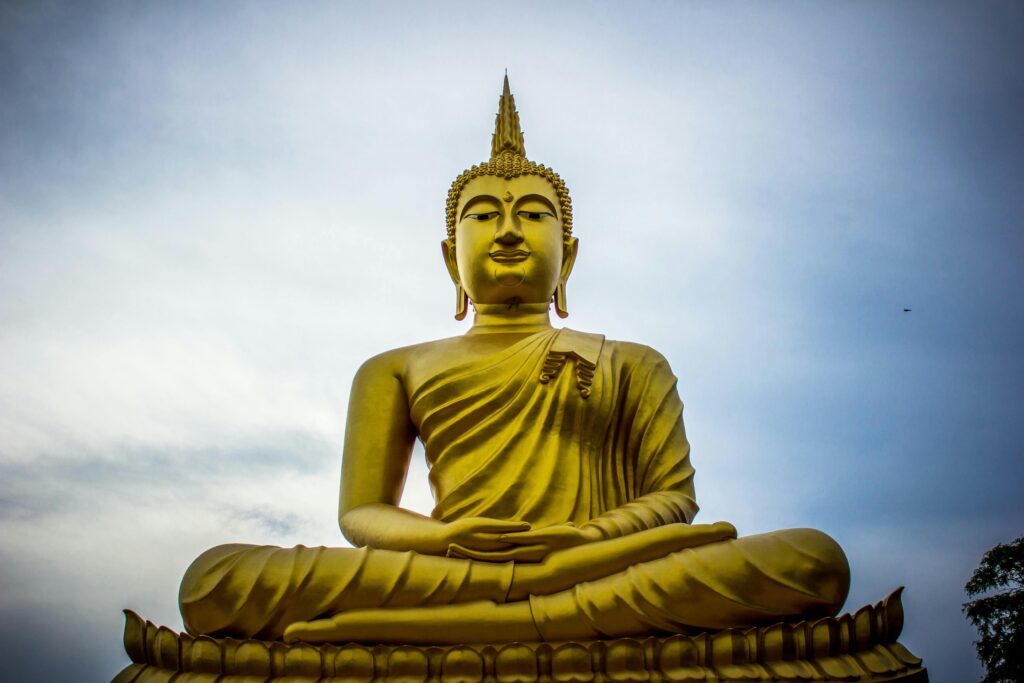 pexels-photo-937465-937465 A majestic golden Buddha statue against a serene blue sky, symbolizing peace and spirituality.